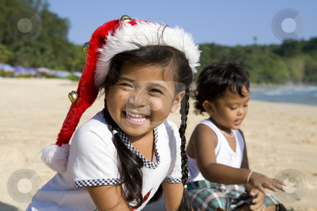 To use this stock image in your creative project, please select the size you need over to the right and click the "Add to Cart" button.
Your downloaded image will come with the Cutcaster watermark removed so don’t worry about the watermark you see on this page. Girl with Christmas hat and boy playing on beach stock photo, Thai girl wearing a Christmas hat with a boy playing on a beach by Magdalena Ascough