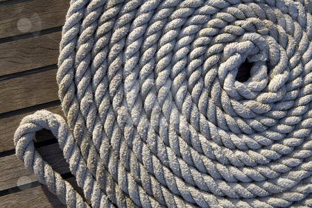 To use this stock image in your creative project, please select the size you need over to the right and click the "Add to Cart" button.
Your downloaded image will come with the Cutcaster watermark removed so don’t worry about the watermark you see on this page. White rope on a wooden surface stock photo, White rope rolled up in a circle on a wooden surface by Magdalena Ascough
