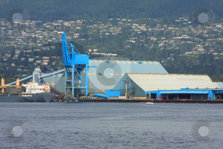 To use this stock image in your creative project, please select the size you need over to the right and click the "Add to Cart" button.
Your downloaded image will come with the Cutcaster watermark removed so don’t worry about the watermark you see on this page. Shipping Port stock photo, Blue buildings and crane loading a ship in the port. by Steve Stedman