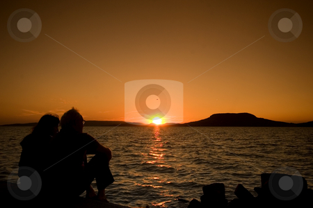 To use this stock image in your creative project, please select the size you need over to the right and click the "Add to Cart" button.
Your downloaded image will come with the Cutcaster watermark removed so don’t worry about the watermark you see on this page. Couple at sunset stock photo, Balaton, calm, clouds, evening, freetime, hills, hungary, lake, lighthouse, mole, nautic, navigation, people, portside, quiet, reflection, relax, sea, starboard, sunset, tourist, travel, walking, water, waves, wind, windy by Fesus Robert