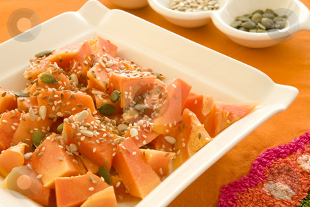 To use this stock image in your creative project, please select the size you need over to the right and click the "Add to Cart" button.
Your downloaded image will come with the Cutcaster watermark removed so don’t worry about the watermark you see on this page. Plate of papaya cubes and mixed seeds stock photo, Freshly cut papay cubes with mixed sunflower, pumpkin, sesame and lintseeds on a square white plate with on an orange tablecloth by Magdalena Ascough