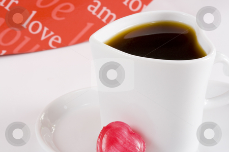 To use this stock image in your creative project, please select the size you need over to the right and click the "Add to Cart" button.
Your downloaded image will come with the Cutcaster watermark removed so don’t worry about the watermark you see on this page. Coffee in white heart shape cup stock photo, Freshly brewed coffee in white heart shape cup with words of love in background by Magdalena Ascough