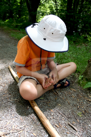 To use this stock image in your creative project, please select the size you need over to the right and click the "Add to Cart" button.
Your downloaded image will come with the Cutcaster watermark removed so don’t worry about the watermark you see on this page. Young boy examining his foot stock photo, Young boy examining his foot on the hiking trail by Sue and Shawn Roberts