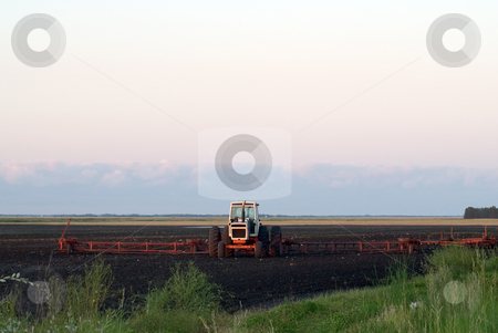 To use this stock image in your creative project, please select the size you need over to the right and click the "Add to Cart" button.
Your downloaded image will come with the Cutcaster watermark removed so don’t worry about the watermark you see on this page. Farm Plow stock photo, A tractor and plow working the soil by Richard Nelson
