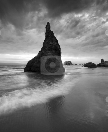 To use this stock image in your creative project, please select the size you need over to the right and click the "Add to Cart" button.
Your downloaded image will come with the Cutcaster watermark removed so don’t worry about the watermark you see on this page. Stone Hat stock photo, A seastack on the ORegon coast near Bandon under a threatening sky looking very much like a stone wizards hat. by Mike Dawson