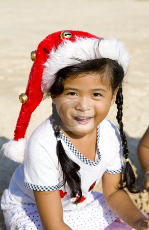 To use this stock image in your creative project, please select the size you need over to the right and click the "Add to Cart" button.
Your downloaded image will come with the Cutcaster watermark removed so don’t worry about the watermark you see on this page. Thai girl with Christmas hat on beach stock photo, Thai girl with Christmas hat playing on beach by Magdalena Ascough