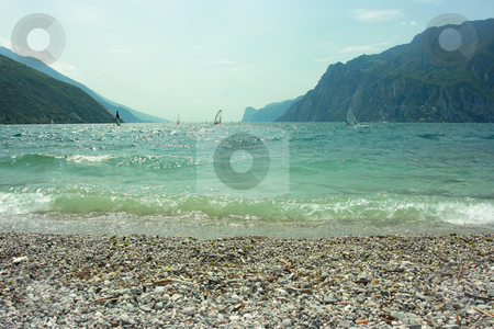 To use this stock image in your creative project, please select the size you need over to the right and click the "Add to Cart" button.
Your downloaded image will come with the Cutcaster watermark removed so don’t worry about the watermark you see on this page. Surfers on Garda lake stock photo, Beautiful view on Garda lake with people practicing surf-riding by Natalia Macheda