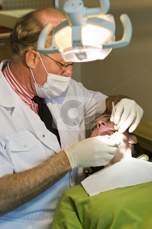 To use this stock image in your creative project, please select the size you need over to the right and click the "Add to Cart" button.
Your downloaded image will come with the Cutcaster watermark removed so don’t worry about the watermark you see on this page. Dentist working stock photo, A mature dentist working on a lady patient. by Nicolaas Traut