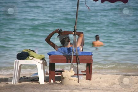 To use this stock image in your creative project, please select the size you need over to the right and click the "Add to Cart" button.
Your downloaded image will come with the Cutcaster watermark removed so don’t worry about the watermark you see on this page. Woman on the beach stock photo, Beautiful woman on sunbed Lamai Beach Koh Samui Island thailand by EVANGELOS THOMAIDIS