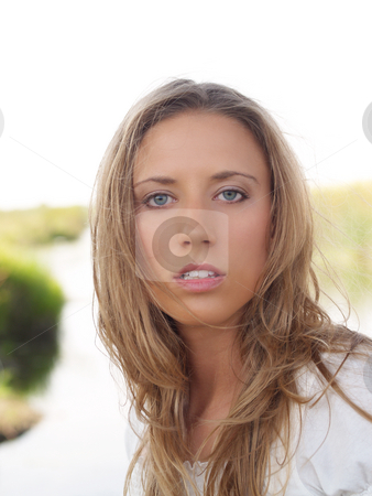 To use this stock image in your creative project, please select the size you need over to the right and click the "Add to Cart" button.
Your downloaded image will come with the Cutcaster watermark removed so don’t worry about the watermark you see on this page. Woman in white stock photo, Young blond woman in white top outdoor portrait by Jeff Cleveland