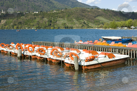 To use this stock image in your creative project, please select the size you need over to the right and click the "Add to Cart" button.
Your downloaded image will come with the Cutcaster watermark removed so don’t worry about the watermark you see on this page. Catamarans on Caldonazzo lake stock photo, Row of colorful catamarans with buoys near wooden quay on Italian Caldonazzo lake near Trento by Natalia Macheda