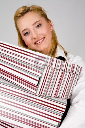To use this stock image in your creative project, please select the size you need over to the right and click the "Add to Cart" button.
Your downloaded image will come with the Cutcaster watermark removed so don’t worry about the watermark you see on this page. Smiling young woman with stack of boxes stock photo, Smiling young woman holding a stack of boxes indoors by Vitaly Sokolovskiy
