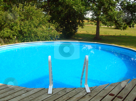 To use this stock image in your creative project, please select the size you need over to the right and click the "Add to Cart" button.
Your downloaded image will come with the Cutcaster watermark removed so don’t worry about the watermark you see on this page. Swimming Pool stock photo, A clear blue above-ground swimming pool. by Crystal Srock