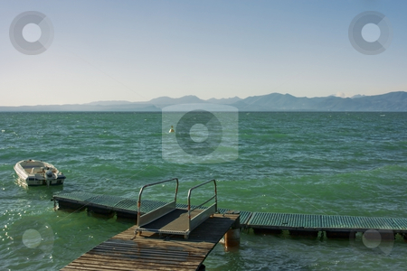 To use this stock image in your creative project, please select the size you need over to the right and click the "Add to Cart" button.
Your downloaded image will come with the Cutcaster watermark removed so don’t worry about the watermark you see on this page. Lago di Garda stock photo, Beautiful view on Garda lake with mountains on horizon by Natalia Macheda