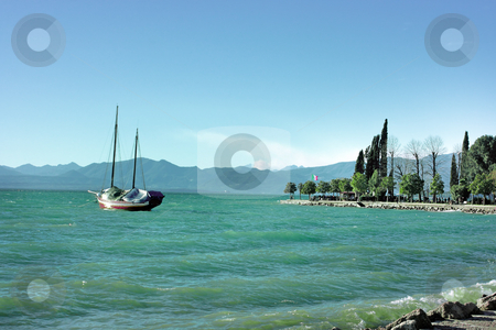 To use this stock image in your creative project, please select the size you need over to the right and click the "Add to Cart" button.
Your downloaded image will come with the Cutcaster watermark removed so don’t worry about the watermark you see on this page. Lake Garda stock photo, Lake Garda in Bardolino (Northern Italy) with ancient ship by Natalia Macheda