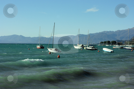 To use this stock image in your creative project, please select the size you need over to the right and click the "Add to Cart" button.
Your downloaded image will come with the Cutcaster watermark removed so don’t worry about the watermark you see on this page. Lake Garda stock photo, Lake Garda with boats and mountains on horizon by Natalia Macheda