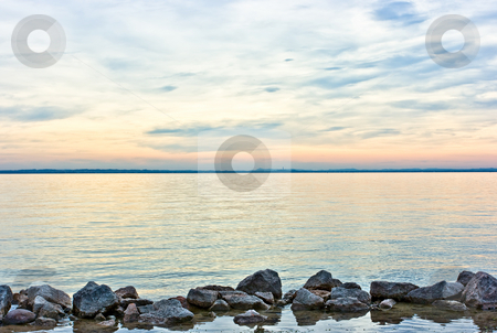 To use this stock image in your creative project, please select the size you need over to the right and click the "Add to Cart" button.
Your downloaded image will come with the Cutcaster watermark removed so don’t worry about the watermark you see on this page. Horizontal theme stock photo, Horizontal theme by means of stones, water, skyline, and sky during dramatic sunset over lake Garda, Italy by Natalia Macheda