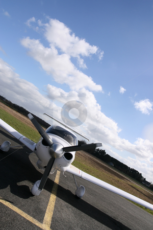 To use this stock image in your creative project, please select the size you need over to the right and click the "Add to Cart" button.
Your downloaded image will come with the Cutcaster watermark removed so don’t worry about the watermark you see on this page. Inclined white plane stock photo, Inclined front view of a white plane on the runway by Tilo