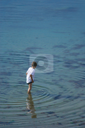 To use this stock image in your creative project, please select the size you need over to the right and click the "Add to Cart" button.
Your downloaded image will come with the Cutcaster watermark removed so don’t worry about the watermark you see on this page. In a clear water stock photo, Young boy standing and looking in the clear water (vl) by Tilo