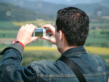 To use this stock image in your creative project, please select the size you need over to the right and click the "Add to Cart" button.
Your downloaded image will come with the Cutcaster watermark removed so don’t worry about the watermark you see on this page. Taking a picture stock photo, Asian man taking a picture by Tilo