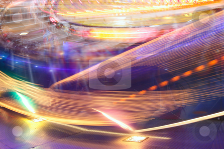 To use this stock image in your creative project, please select the size you need over to the right and click the "Add to Cart" button.
Your downloaded image will come with the Cutcaster watermark removed so don’t worry about the watermark you see on this page. Spinning lights stock photo, Blur neon lights in amusement park by Tilo