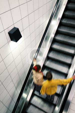 To use this stock image in your creative project, please select the size you need over to the right and click the "Add to Cart" button.
Your downloaded image will come with the Cutcaster watermark removed so don’t worry about the watermark you see on this page. Escalator, grey stock photo, Couple moving on escalator, with motion blur by Tilo