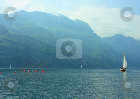 To use this stock image in your creative project, please select the size you need over to the right and click the "Add to Cart" button.
Your downloaded image will come with the Cutcaster watermark removed so don’t worry about the watermark you see on this page. Sailboat on Garda lake stock photo, Sailboat on Garda lake early hazy morning by Natalia Macheda