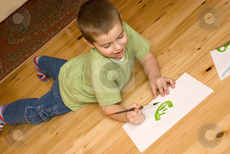 To use this stock image in your creative project, please select the size you need over to the right and click the "Add to Cart" button.
Your downloaded image will come with the Cutcaster watermark removed so don’t worry about the watermark you see on this page. Boy artist stock photo, A boy is painting on the floor by Ivan Paunovic