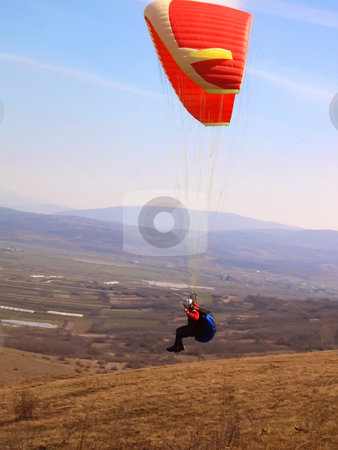 To use this stock image in your creative project, please select the size you need over to the right and click the "Add to Cart" button.
Your downloaded image will come with the Cutcaster watermark removed so don’t worry about the watermark you see on this page. Paragliding stock photo, Paragliding airborne over valley with hills in distance by Ivan Paunovic