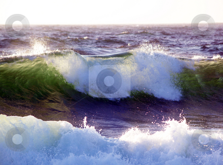 To use this stock image in your creative project, please select the size you need over to the right and click the "Add to Cart" button.
Your downloaded image will come with the Cutcaster watermark removed so don’t worry about the watermark you see on this page. Wave breaking with sunlight coming through from behind stock photo, Waves starting to break backlit by sunlight by Jeff Cleveland