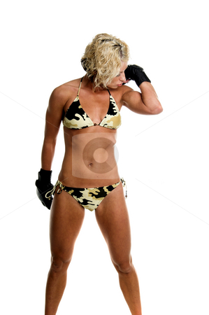 To use this stock image in your creative project, please select the size you need over to the right and click the "Add to Cart" button.
Your downloaded image will come with the Cutcaster watermark removed so don’t worry about the watermark you see on this page. Female MMA Fighter stock photo, Sexy blond mixed martial arts fighter in a camo bikini and MMA style gloves kissing her guns by Robert Deal