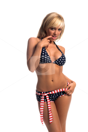 To use this stock image in your creative project, please select the size you need over to the right and click the "Add to Cart" button.
Your downloaded image will come with the Cutcaster watermark removed so don’t worry about the watermark you see on this page. Patriotic Bikini Blonde stock photo, Sexy blond swim wear model in a red white and blue, stars and stripes bikini with a booty short bottom with a flag stripped belt and chewing on her fingernail by Robert Deal