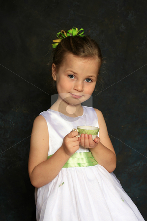 To use this stock image in your creative project, please select the size you need over to the right and click the "Add to Cart" button.
Your downloaded image will come with the Cutcaster watermark removed so don’t worry about the watermark you see on this page. Tea party stock photo, Cute little girl in a white dress holding a tea cup by Anita Peppers