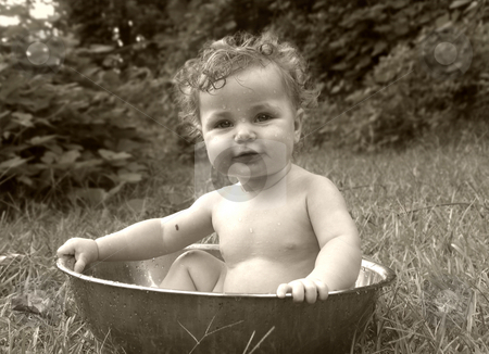 To use this stock image in your creative project, please select the size you need over to the right and click the "Add to Cart" button.
Your downloaded image will come with the Cutcaster watermark removed so don’t worry about the watermark you see on this page. Baby bath stock photo, Baby in a tub outdoors in sepia by Anita Peppers