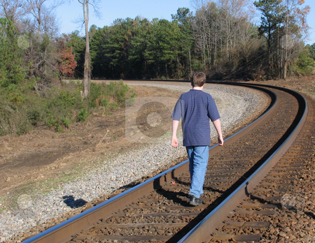 To use this stock image in your creative project, please select the size you need over to the right and click the "Add to Cart" button.
Your downloaded image will come with the Cutcaster watermark removed so don’t worry about the watermark you see on this page. Boy on tracks stock photo, Teen boy walking on train tracks by Anita Peppers