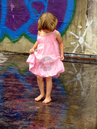 To use this stock image in your creative project, please select the size you need over to the right and click the "Add to Cart" button.
Your downloaded image will come with the Cutcaster watermark removed so don’t worry about the watermark you see on this page. Reflections stock photo, Little girl playing in puddles with graffiti reflected by Anita Peppers
