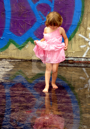 To use this stock image in your creative project, please select the size you need over to the right and click the "Add to Cart" button.
Your downloaded image will come with the Cutcaster watermark removed so don’t worry about the watermark you see on this page. Reflections 2 stock photo, Little girl playing in rain puddles with reflections by Anita Peppers