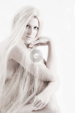 To use this stock image in your creative project, please select the size you need over to the right and click the "Add to Cart" button.
Your downloaded image will come with the Cutcaster watermark removed so don’t worry about the watermark you see on this page. Long blond haired artistic beauty checking you out stock photo, High key studio shot a an artistic girl with very long blond hair by Frenk and Danielle Kaufmann