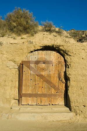 To use this stock image in your creative project, please select the size you need over to the right and click the "Add to Cart" button.
Your downloaded image will come with the Cutcaster watermark removed so don’t worry about the watermark you see on this page. Antique door of a house carved in a cliff. stock photo, Antique door of a house carved in a cliff in patagonia, argentina. by Pablo Caridad
