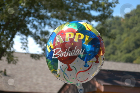 To use this stock image in your creative project, please select the size you need over to the right and click the "Add to Cart" button.
Your downloaded image will come with the Cutcaster watermark removed so don’t worry about the watermark you see on this page. Happy birthday ballon stock photo, A mylar happy birthday ballon at a party by Tim Markley