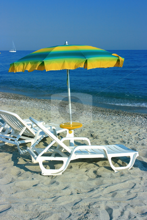 To use this stock image in your creative project, please select the size you need over to the right and click the "Add to Cart" button.
Your downloaded image will come with the Cutcaster watermark removed so don’t worry about the watermark you see on this page. Colorful parasol stock photo, Colorful parasol over two chaise-longues on a beach by Natalia Macheda