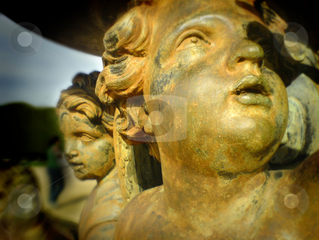 To use this stock image in your creative project, please select the size you need over to the right and click the "Add to Cart" button.
Your downloaded image will come with the Cutcaster watermark removed so don’t worry about the watermark you see on this page. Golden angel statue stock photo, Two golden angels in a parc by Heiko Riemann