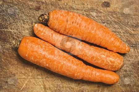 To use this stock image in your creative project, please select the size you need over to the right and click the "Add to Cart" button.
Your downloaded image will come with the Cutcaster watermark removed so don’t worry about the watermark you see on this page. Three carrots on a cutting table. stock photo, Three carrots on a cutting table. by Pablo Caridad