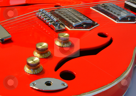 To use this stock image in your creative project, please select the size you need over to the right and click the "Add to Cart" button.
Your downloaded image will come with the Cutcaster watermark removed so don’t worry about the watermark you see on this page. Red guitar stock photo, A red electric acoustic guitar closeup with sound holes by Sam Sapp
