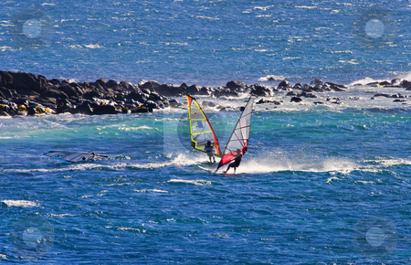 To use this stock image in your creative project, please select the size you need over to the right and click the "Add to Cart" button.
Your downloaded image will come with the Cutcaster watermark removed so don’t worry about the watermark you see on this page. Two wind surfer stock photo, A trio of windsurfers riding the wind and waves off the North Coast of Maui, Hawaii. by Mike Dawson