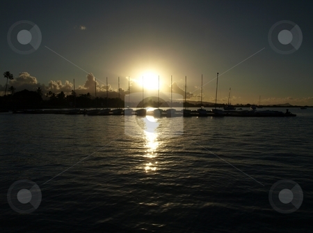 To use this stock image in your creative project, please select the size you need over to the right and click the "Add to Cart" button.
Your downloaded image will come with the Cutcaster watermark removed so don’t worry about the watermark you see on this page. Hickam Beach, Oahu, Sailboats, rising sun. stock photo, Sunrise over Hickam AFB Beach marina. by Peter Rolfe