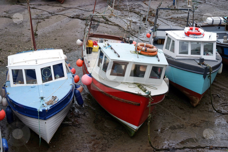To use this stock image in your creative project, please select the size you need over to the right and click the "Add to Cart" button.
Your downloaded image will come with the Cutcaster watermark removed so don’t worry about the watermark you see on this page. Low tide stock photo, Three fishing boats at low tide by Paul Phillips