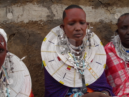 To use this stock image in your creative project, please select the size you need over to the right and click the "Add to Cart" button.
Your downloaded image will come with the Cutcaster watermark removed so don’t worry about the watermark you see on this page. Tanzanian Masai Woman with red ocre on face stock photo, A Masai Woman from Tanzania with red ocre on her face wearing white beaded necklaces by Rose Nthiwa