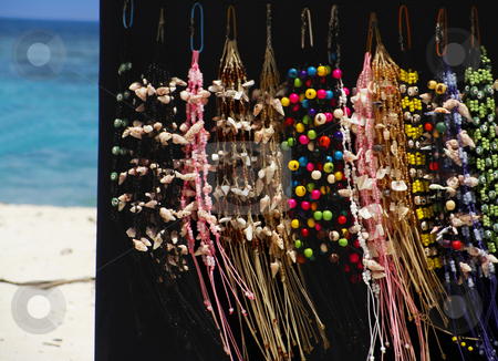 To use this stock image in your creative project, please select the size you need over to the right and click the "Add to Cart" button.
Your downloaded image will come with the Cutcaster watermark removed so don’t worry about the watermark you see on this page. Jewerly stock photo, Beach vendor selling beautiful colorful jewerly by Maria Alessandra Nusiner