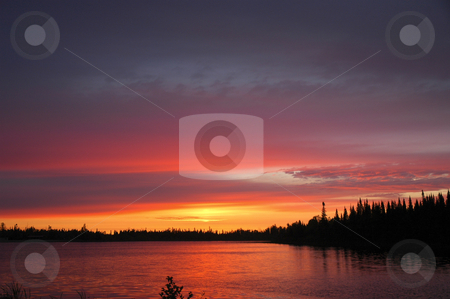 To use this stock image in your creative project, please select the size you need over to the right and click the "Add to Cart" button.
Your downloaded image will come with the Cutcaster watermark removed so don’t worry about the watermark you see on this page. Fiery Sunrise stock photo, Glowing sunrise reflecting in small lake by Pierre Landry